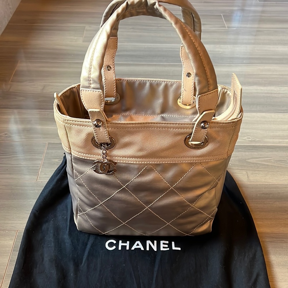 Chanel Metallic Gold Canvas Quilted Tote with Chanel Charm in Silver Metal.